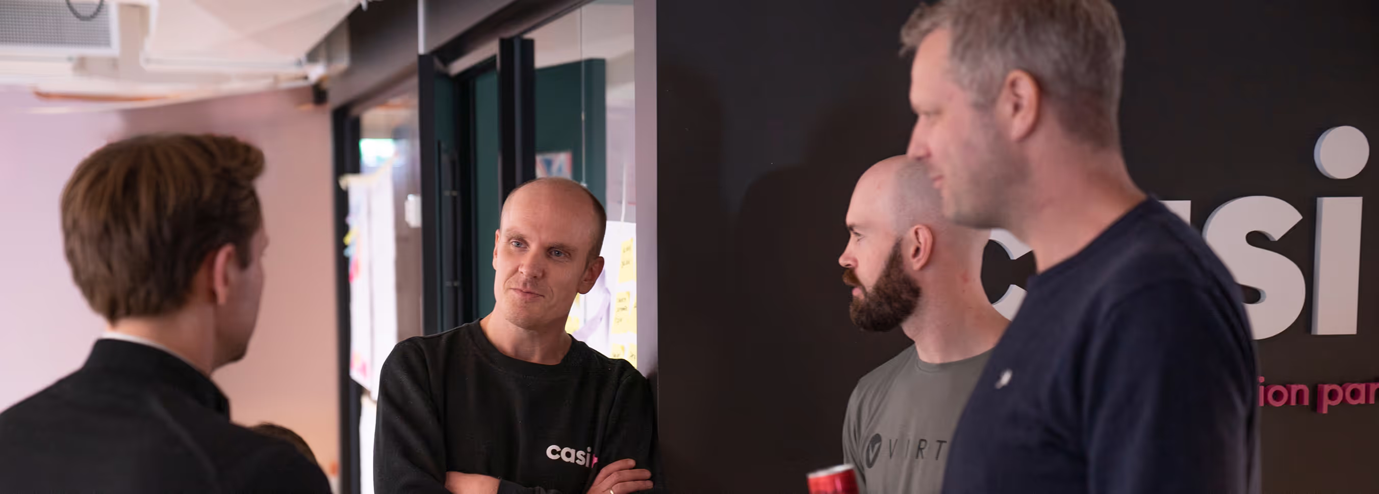Casi colleagues in conversation in the office