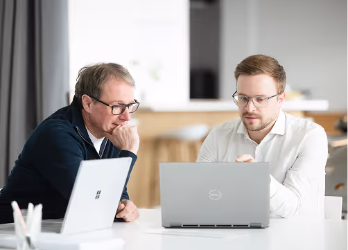 Two colleagues focusing together on a task.