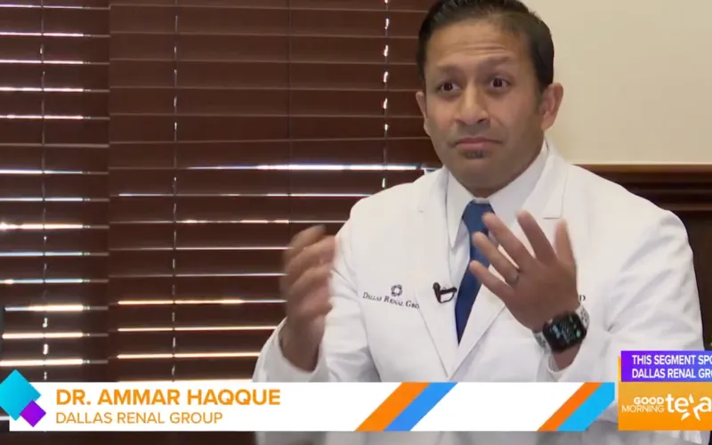 Dr. Ammar Haqque from Dallas Renal Group speaking during a televised interview, wearing a white coat and blue tie.