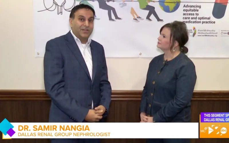 Dr. Samir Nangia, a nephrologist from Dallas Renal Group, stands and speaks next to a woman in front of a banner about kidney disease care.