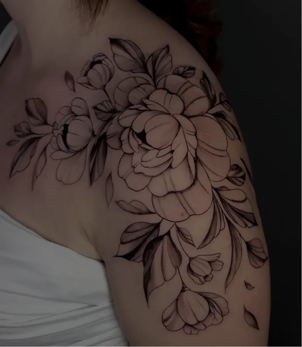 Black and grey tattoo of a realistic eye above a skull with a tree and hanging figures on the arm.