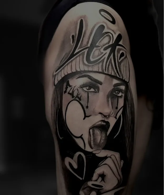 Black and grey tattoo of a realistic eye above a skull with a tree and hanging figures on the arm.