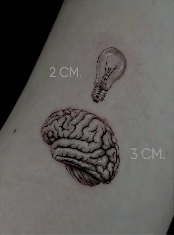 Black and grey tattoo of a realistic eye above a skull with a tree and hanging figures on the arm.