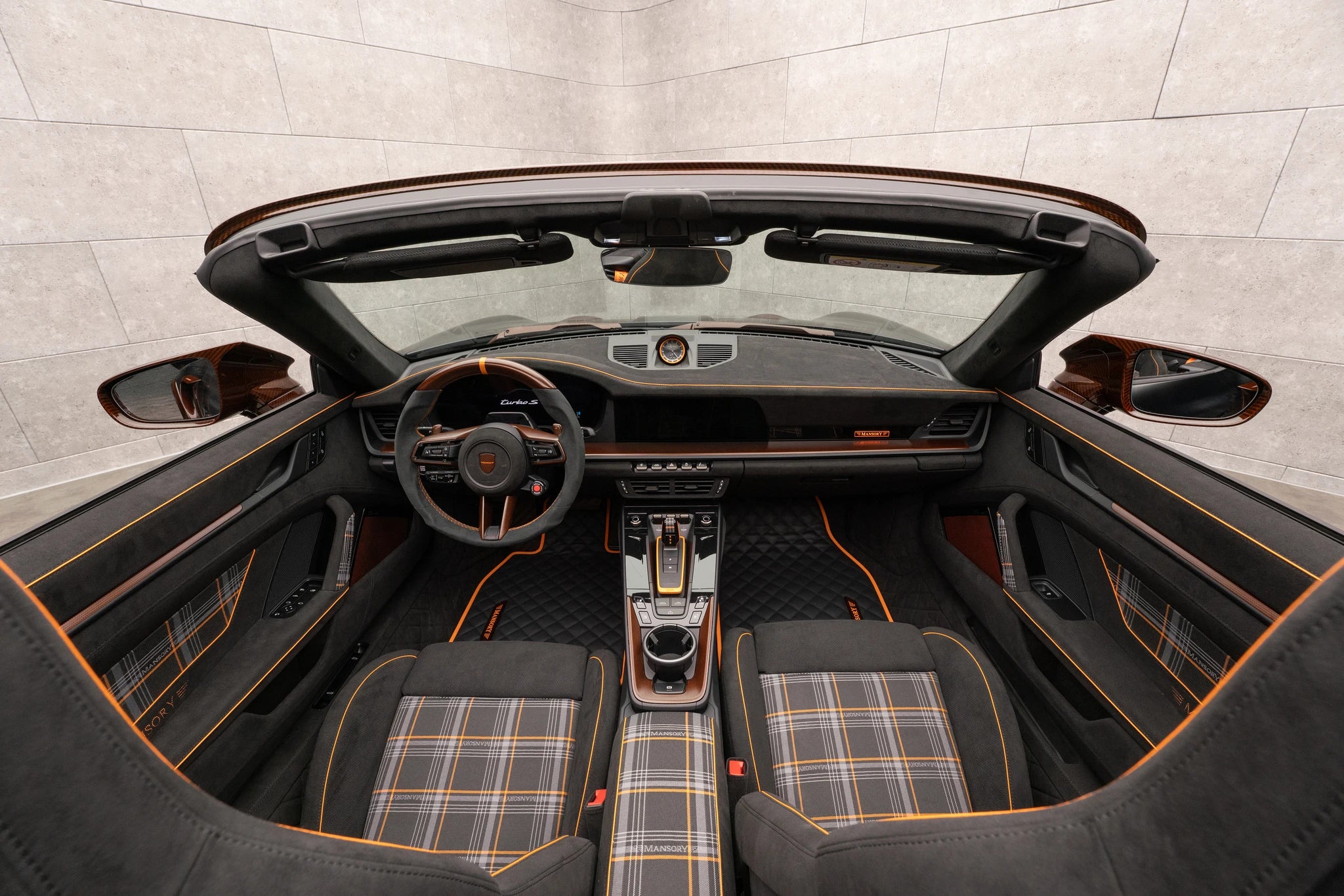 Habitacle de la Mansory Porsche 992.2 Turbo S Cabriolet avec sellerie quadrillée et accents aux tons chauds