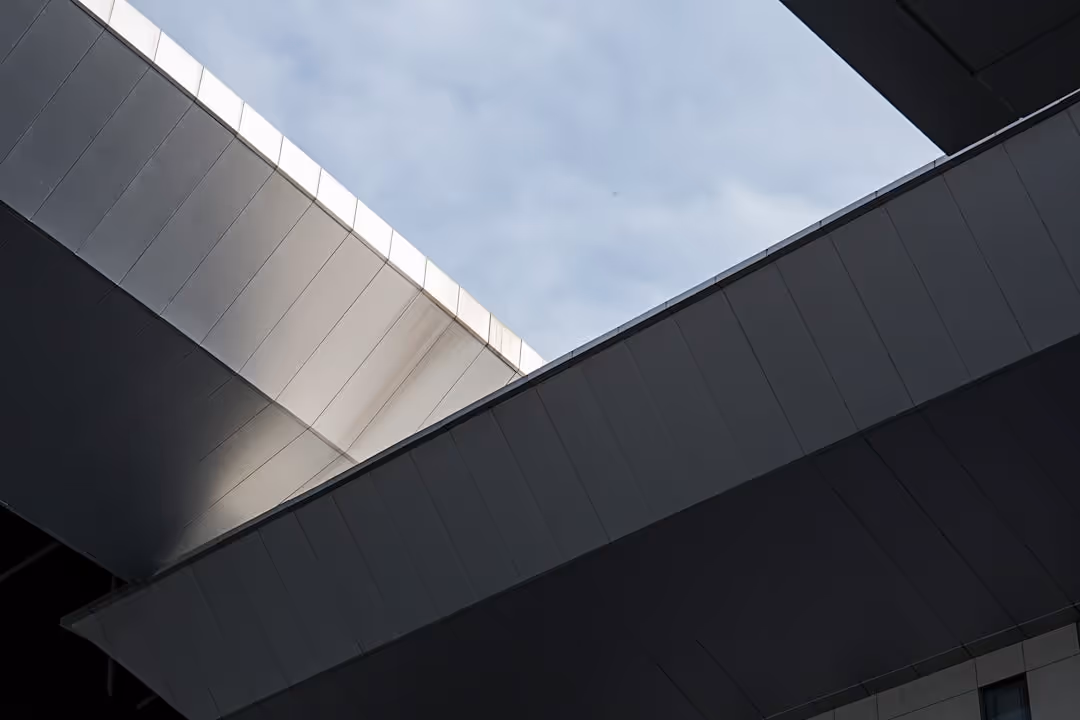 A large building with a gray roof.