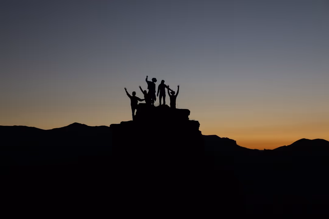 A group of people standing on top of a mountain.