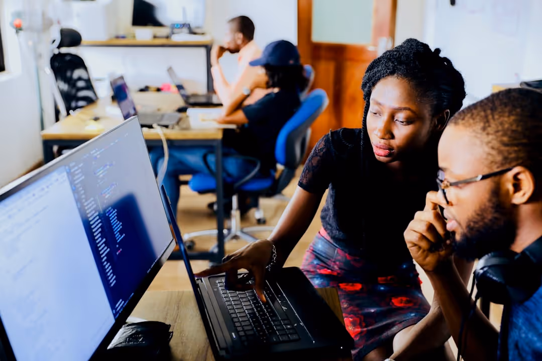 Two people looking at a computer screen.