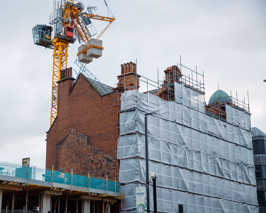 A building with a crane on top of it.