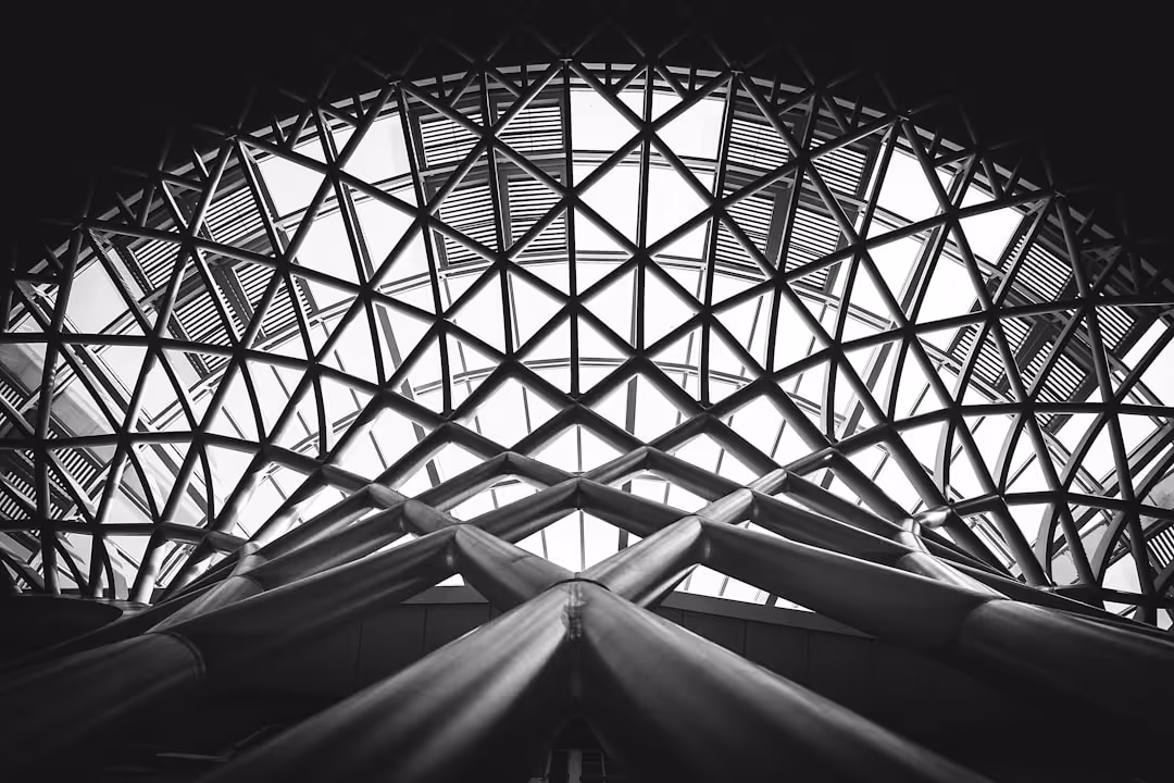 A black and white photo of a building with a large glass dome.