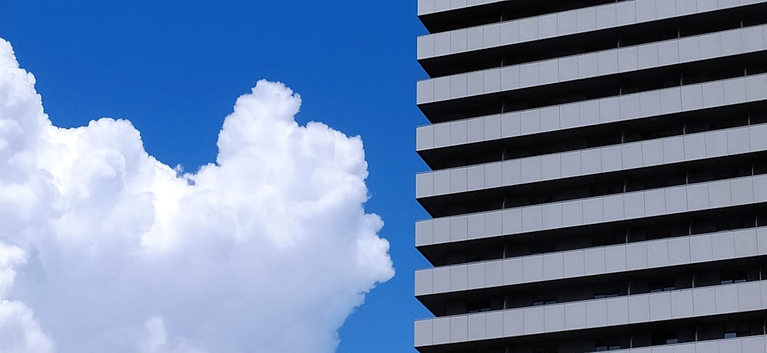 A large white building with a cloud in front of it.