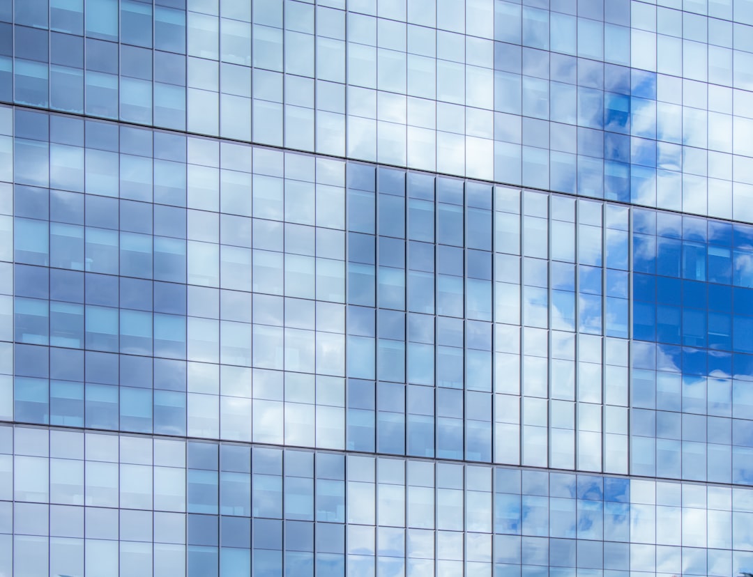 A large building with many windows and a blue sky.