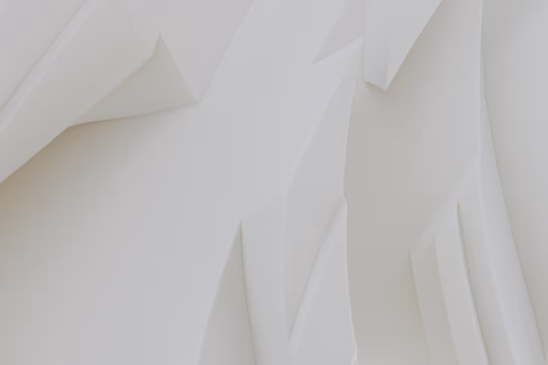 A close up of a white wall with a clock on it