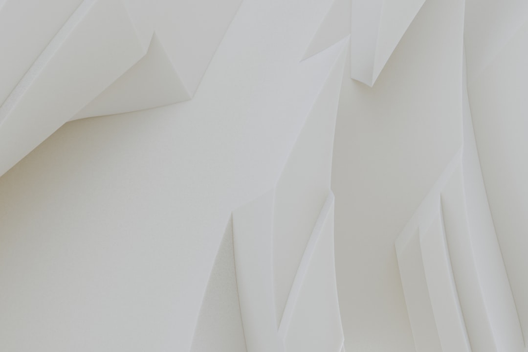 A close up of a white wall with a clock on it