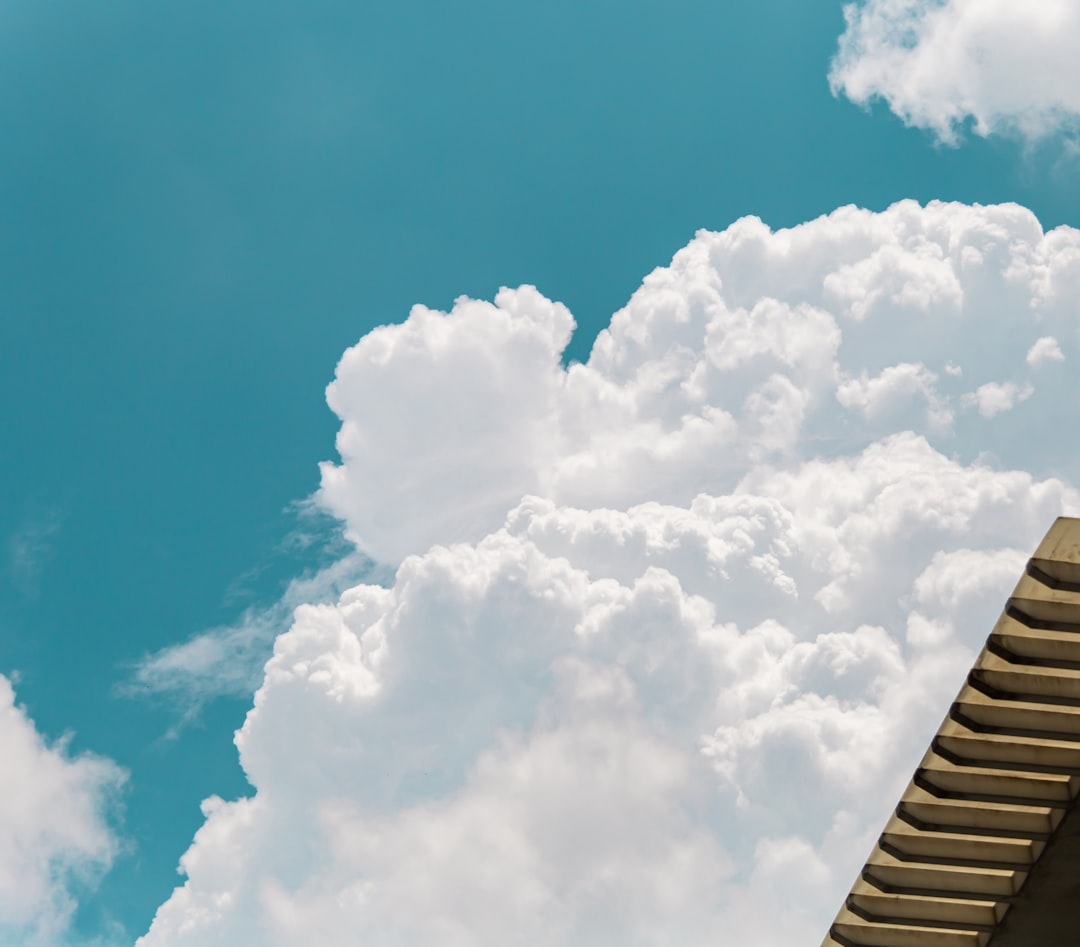 a plane flying in the sky with a lot of clouds