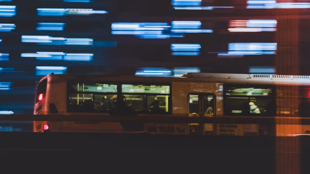 a trolley car traveling down a street at night