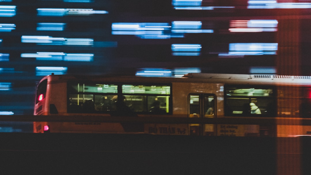 a trolley car traveling down a street at night