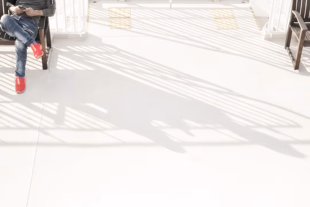 A man sitting on a bench looking at his cell phone