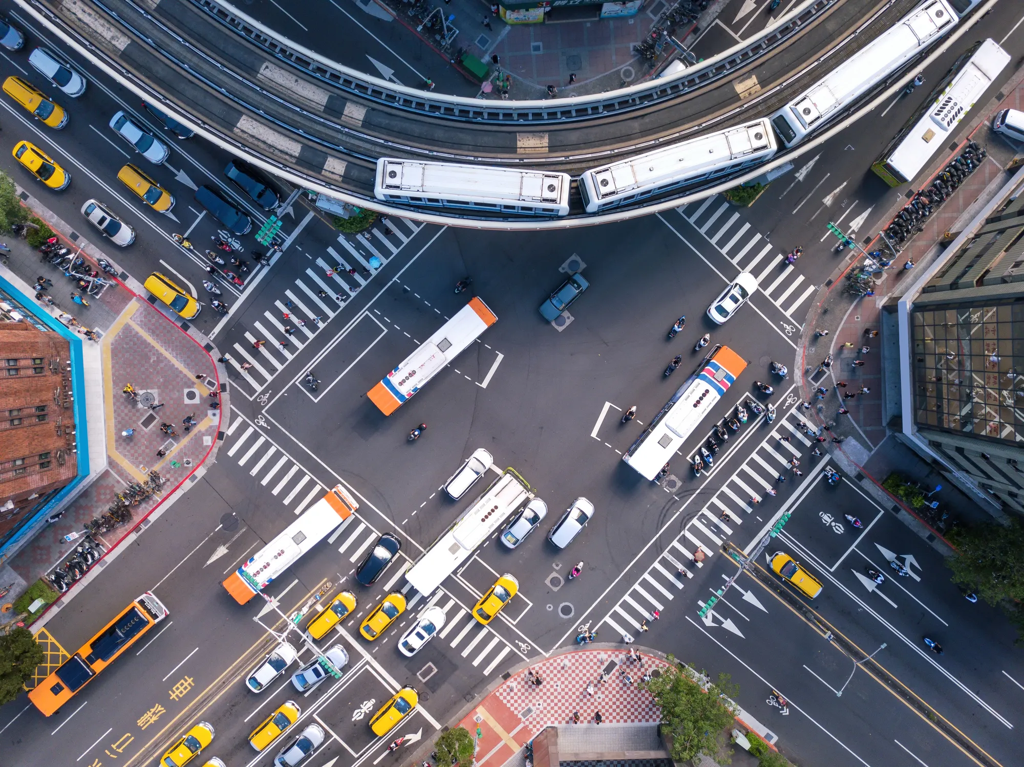 A busy intersection with many vehicles and people.