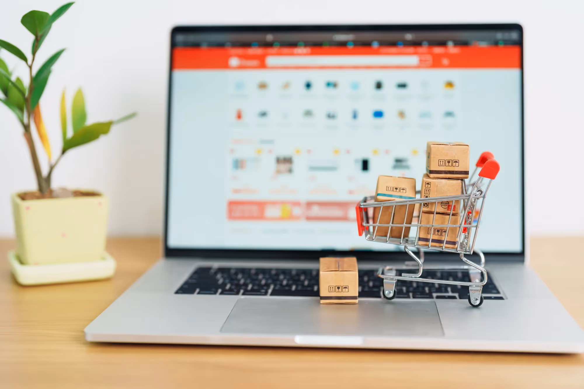 A laptop with a shopping cart on it.