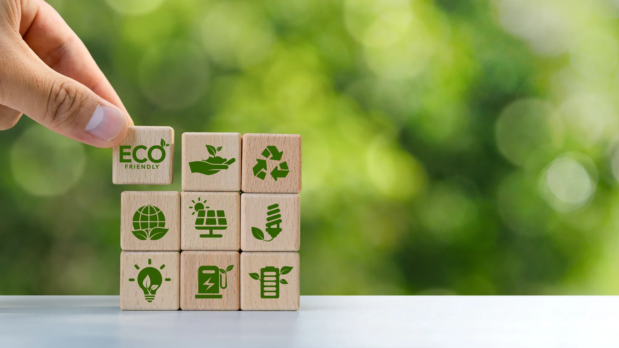 A stack of wooden blocks with green symbols on them.