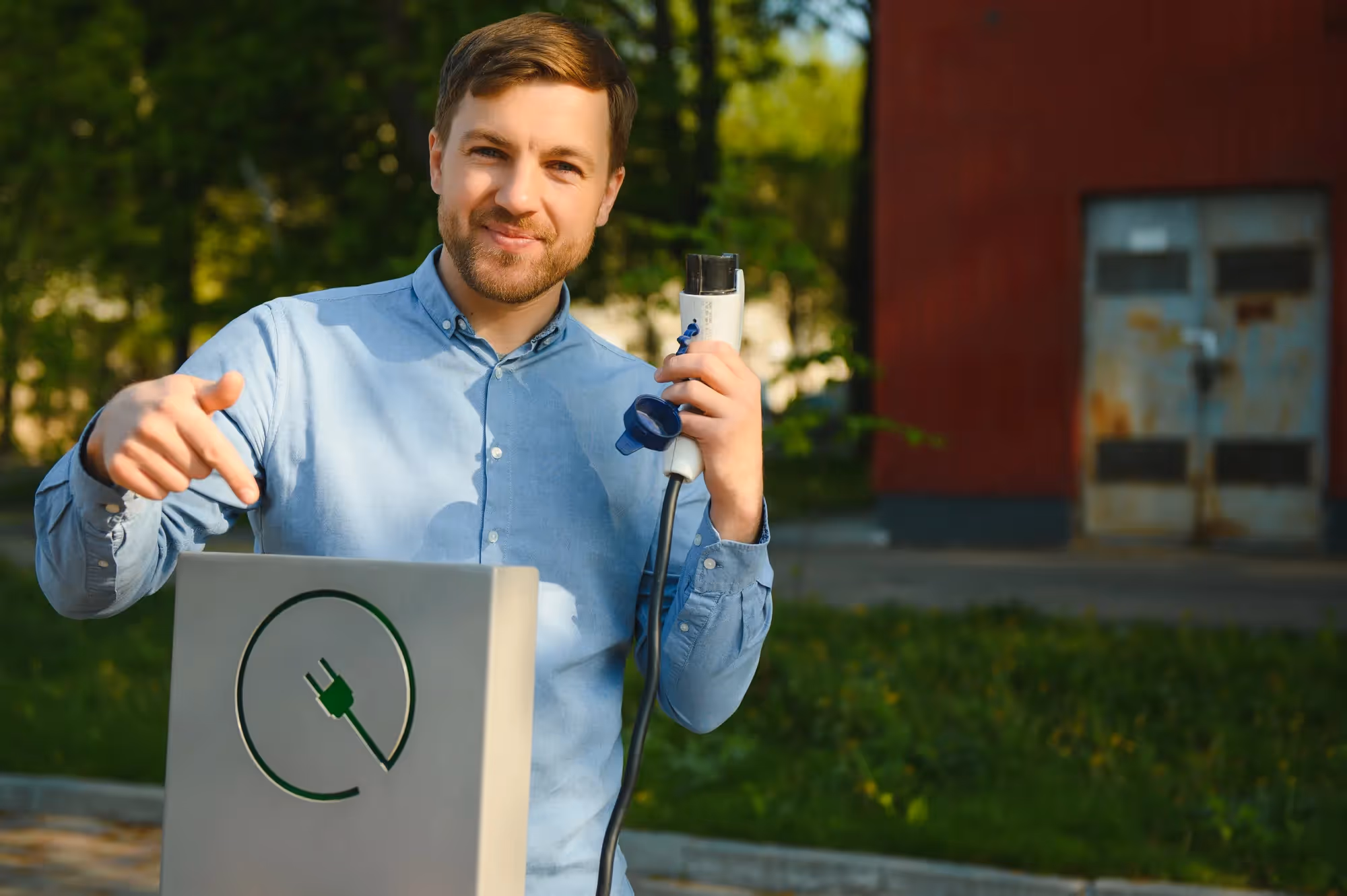 A man holding a device that charges his phone.
