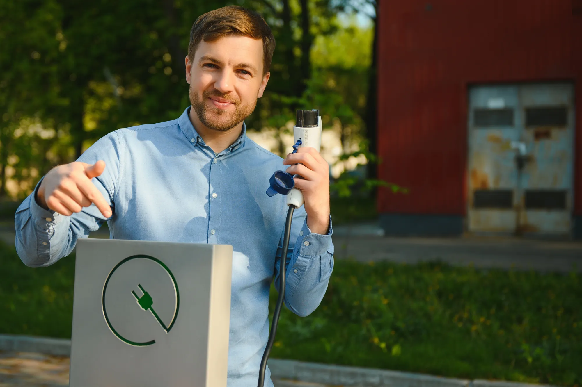 A man holding a device that charges his phone.