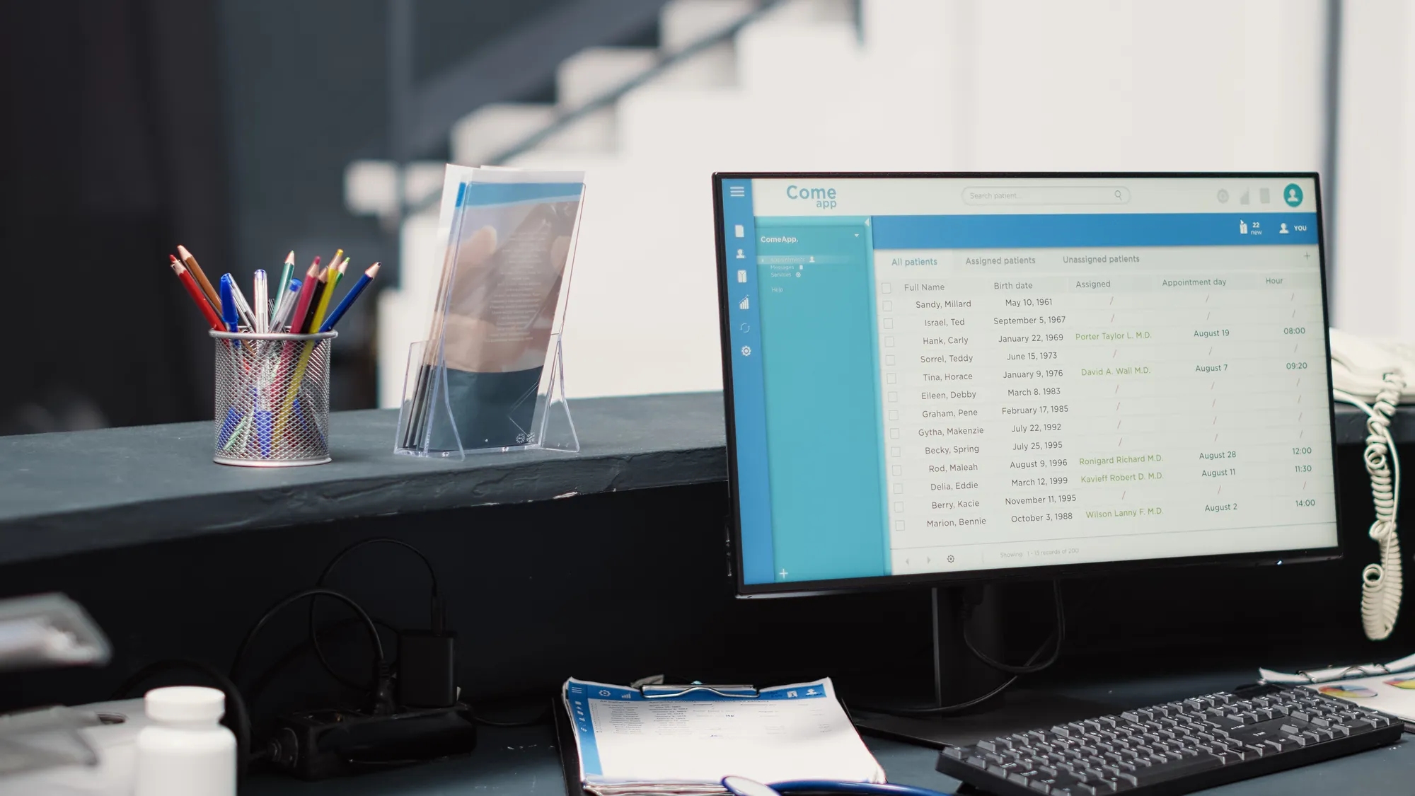 A computer monitor with a blue screen displaying a list of names.