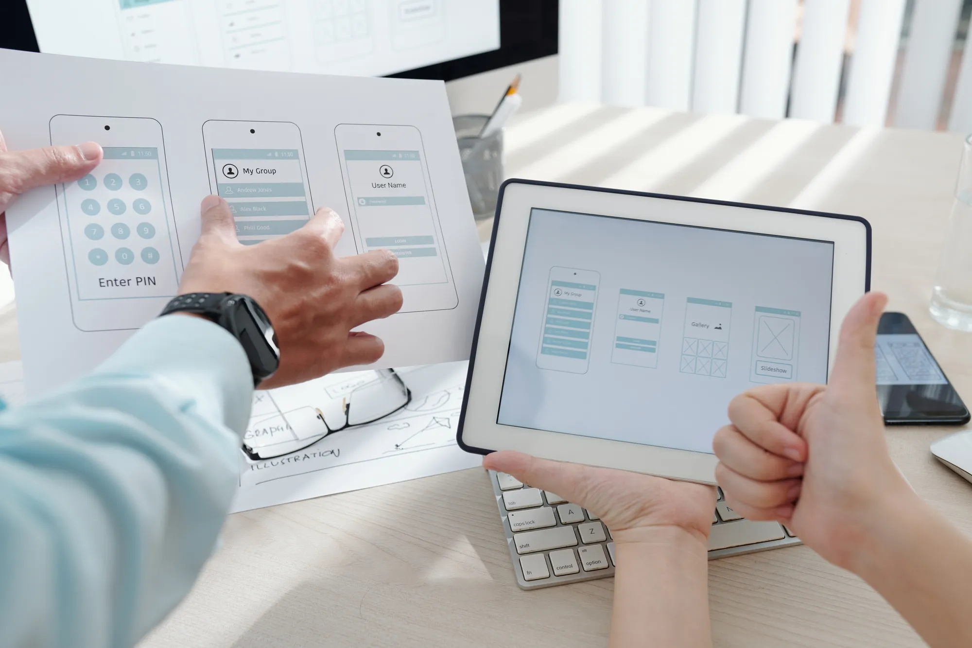 A person holding a tablet with a screen displaying a diagram.