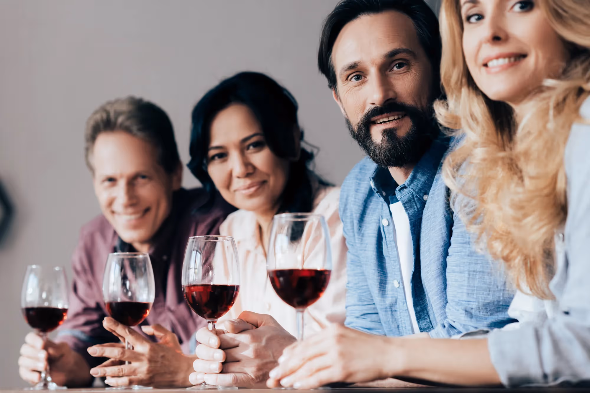 A group of people holding wine glasses.