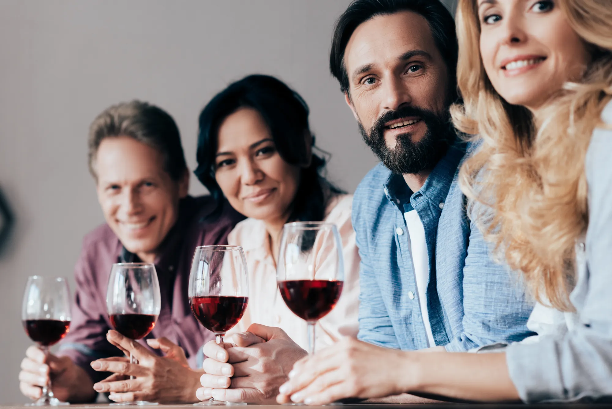 A group of people holding wine glasses.