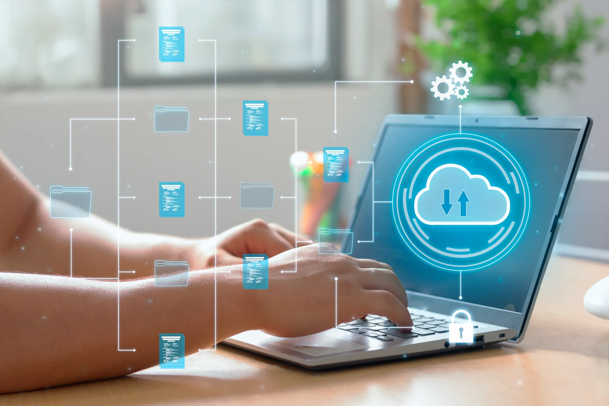 A person is using a laptop with a cloud icon on the screen.