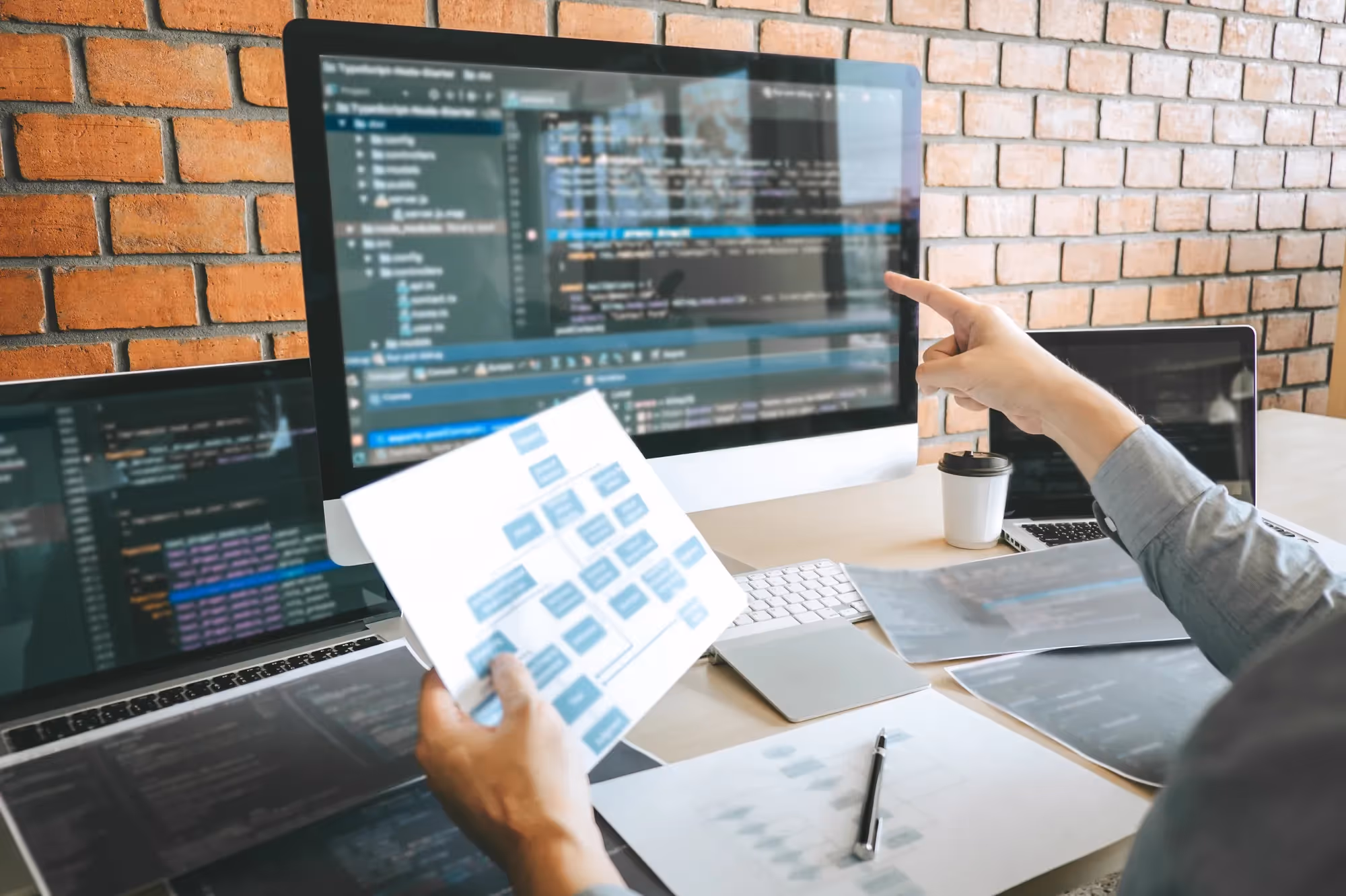 A man pointing at a computer screen with a pen.