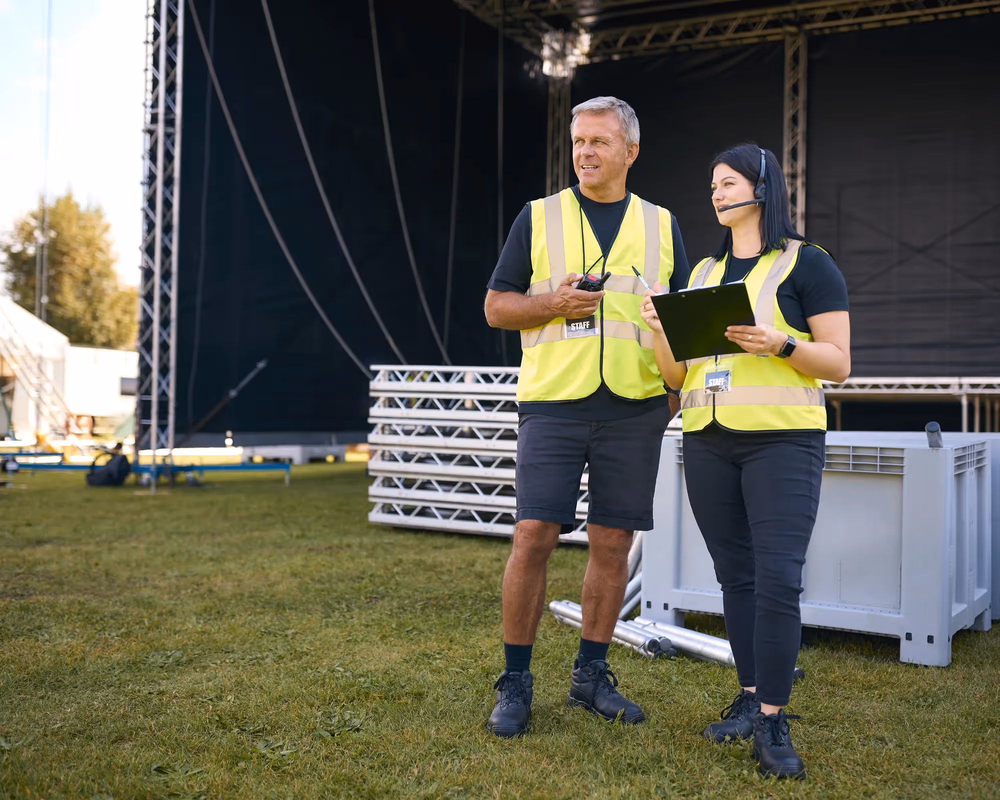 Two people standing in front of a stage.