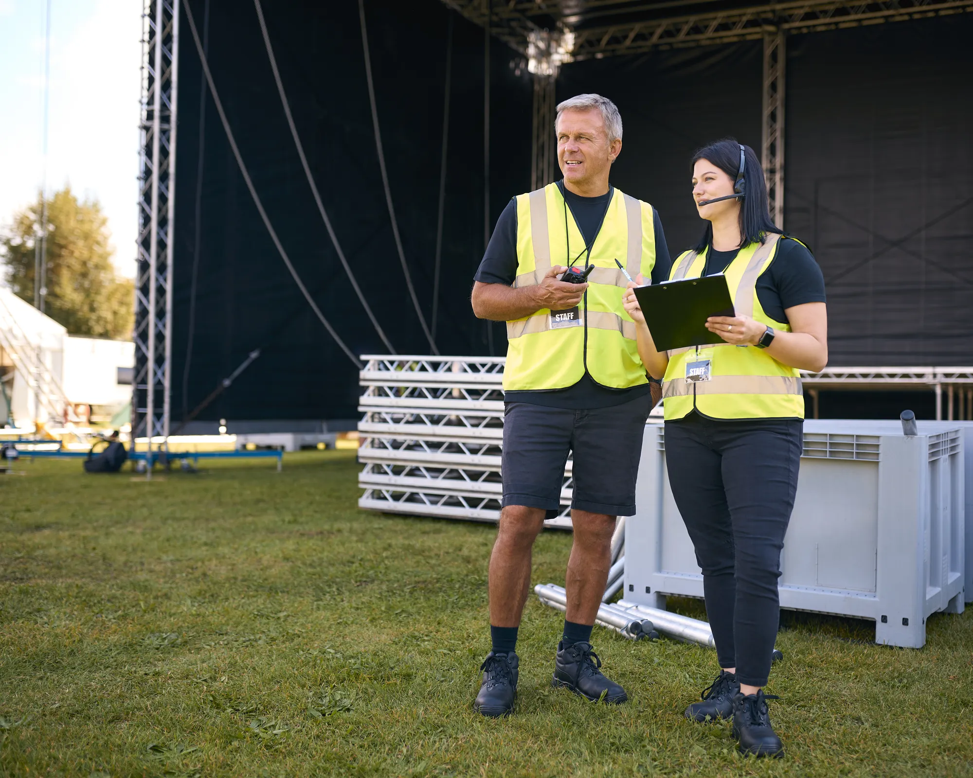 Two people standing in front of a stage.