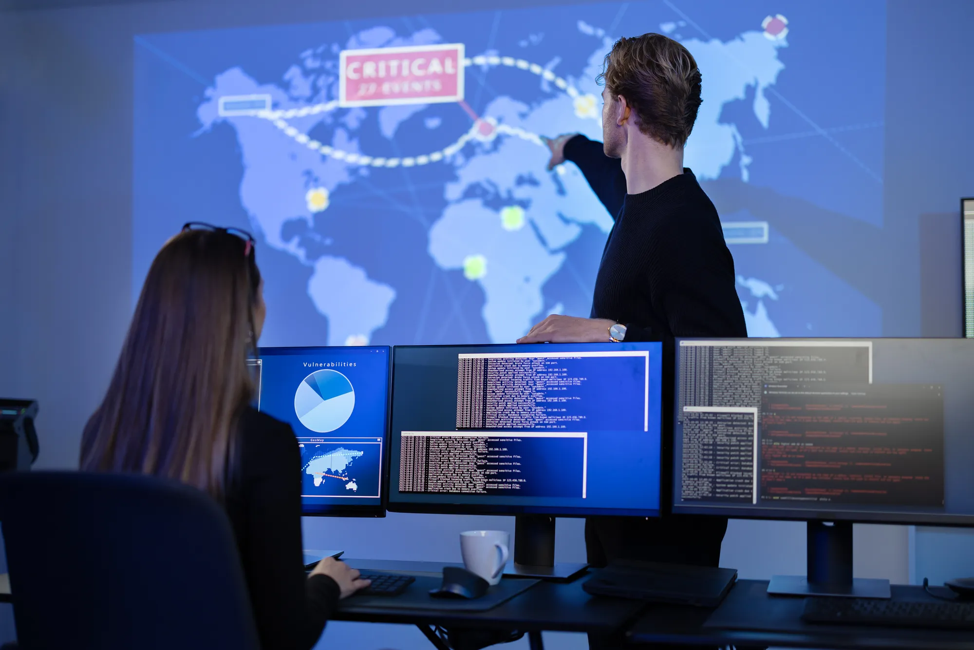 A man pointing at a map on a computer screen.
