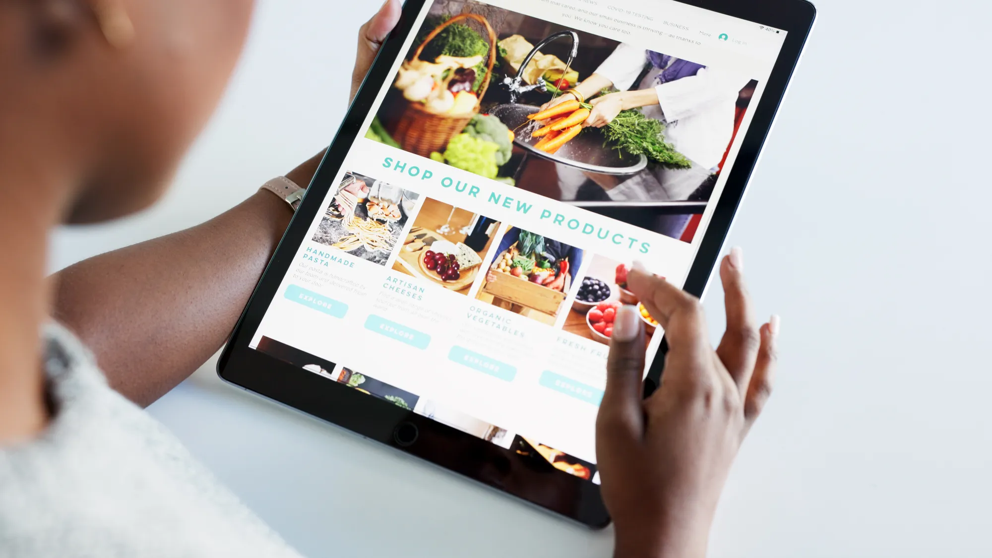 A person holding a tablet with a website about food products.