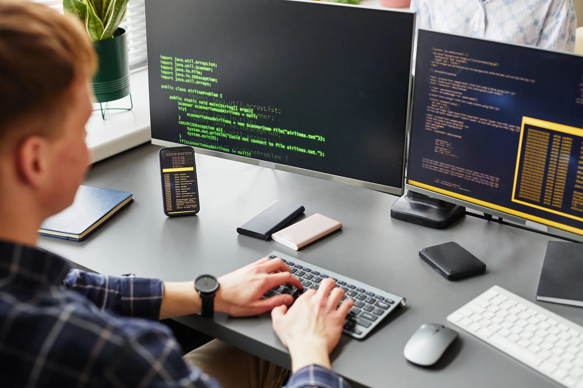 A man is typing on a computer keyboard.