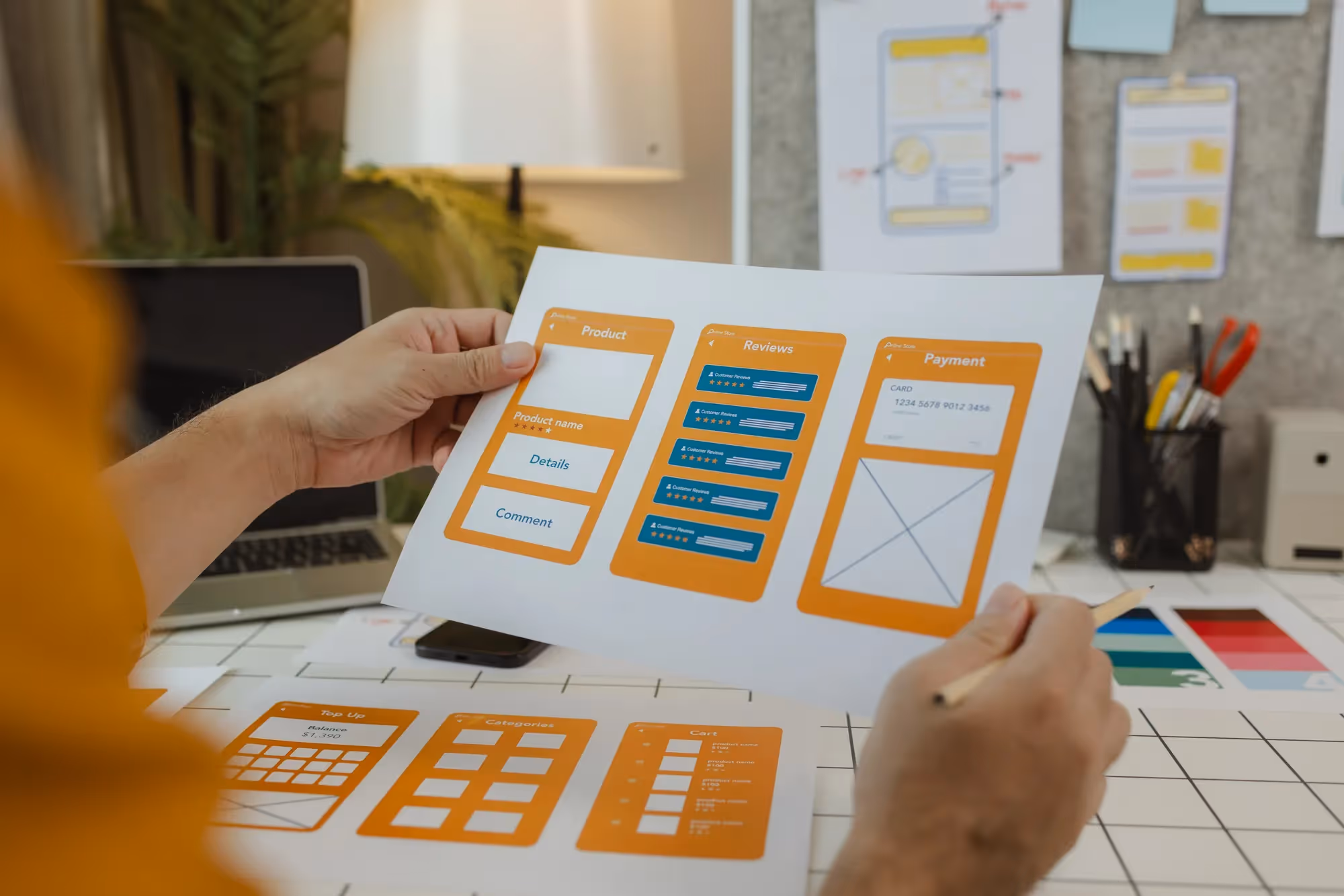 A person holding a piece of paper with a website design on it.