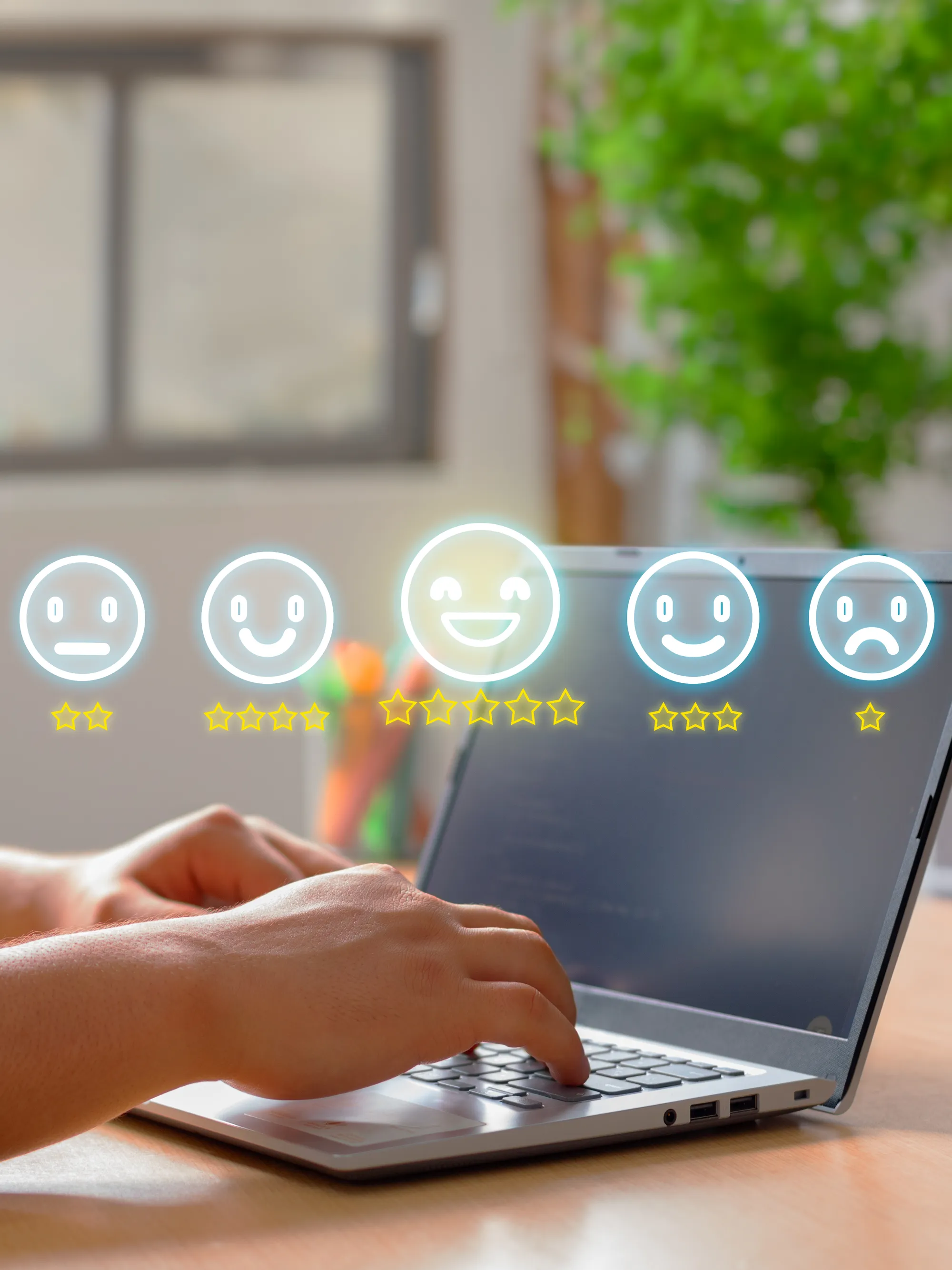 A person is using a laptop with a bunch of smiley faces.