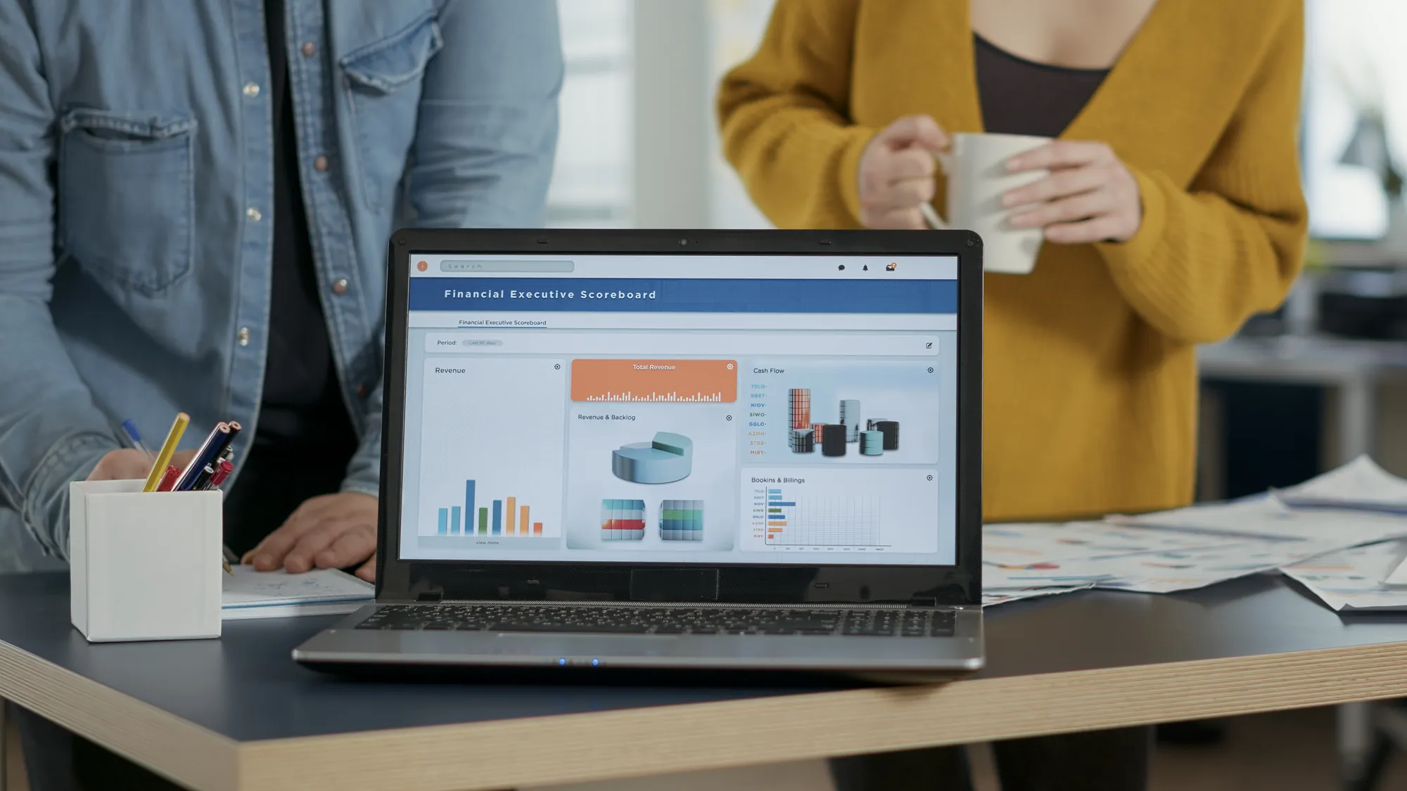 A laptop displaying a financial executive scoreboard.