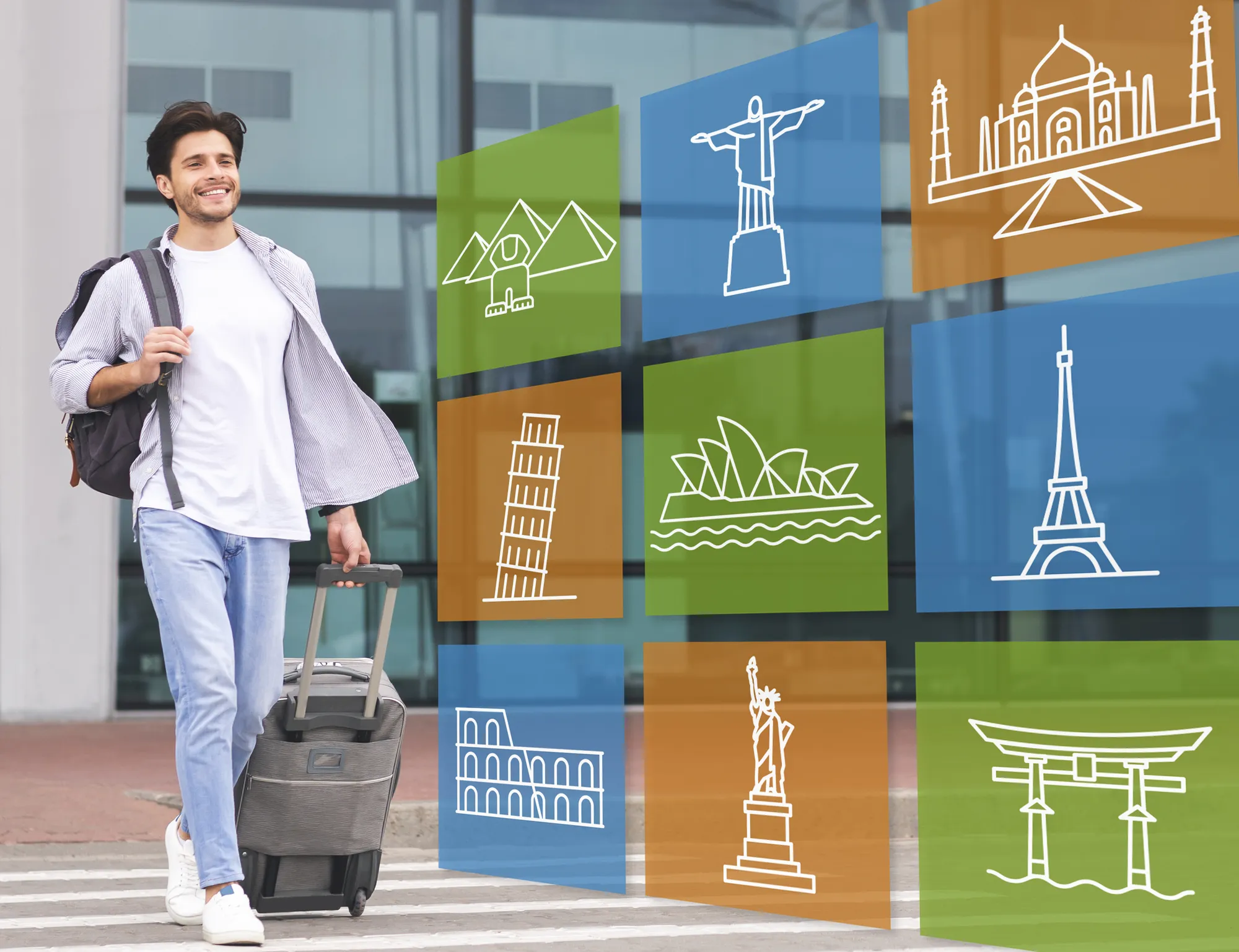 A man is walking with a suitcase and pulling a cart with a picture of the Eiffel Tower on it.