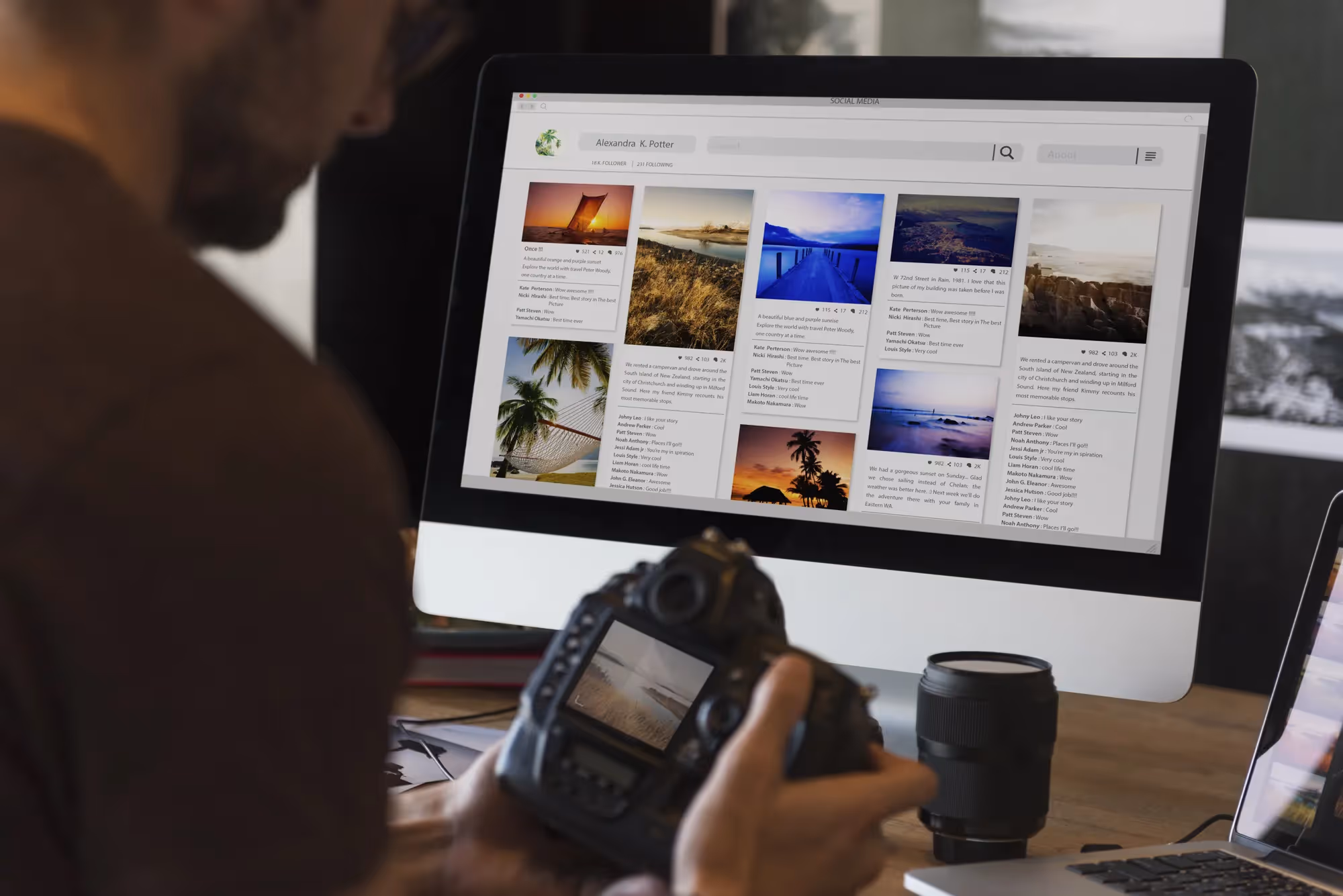 A man holding a camera in front of a computer screen with a slide show of pictures.