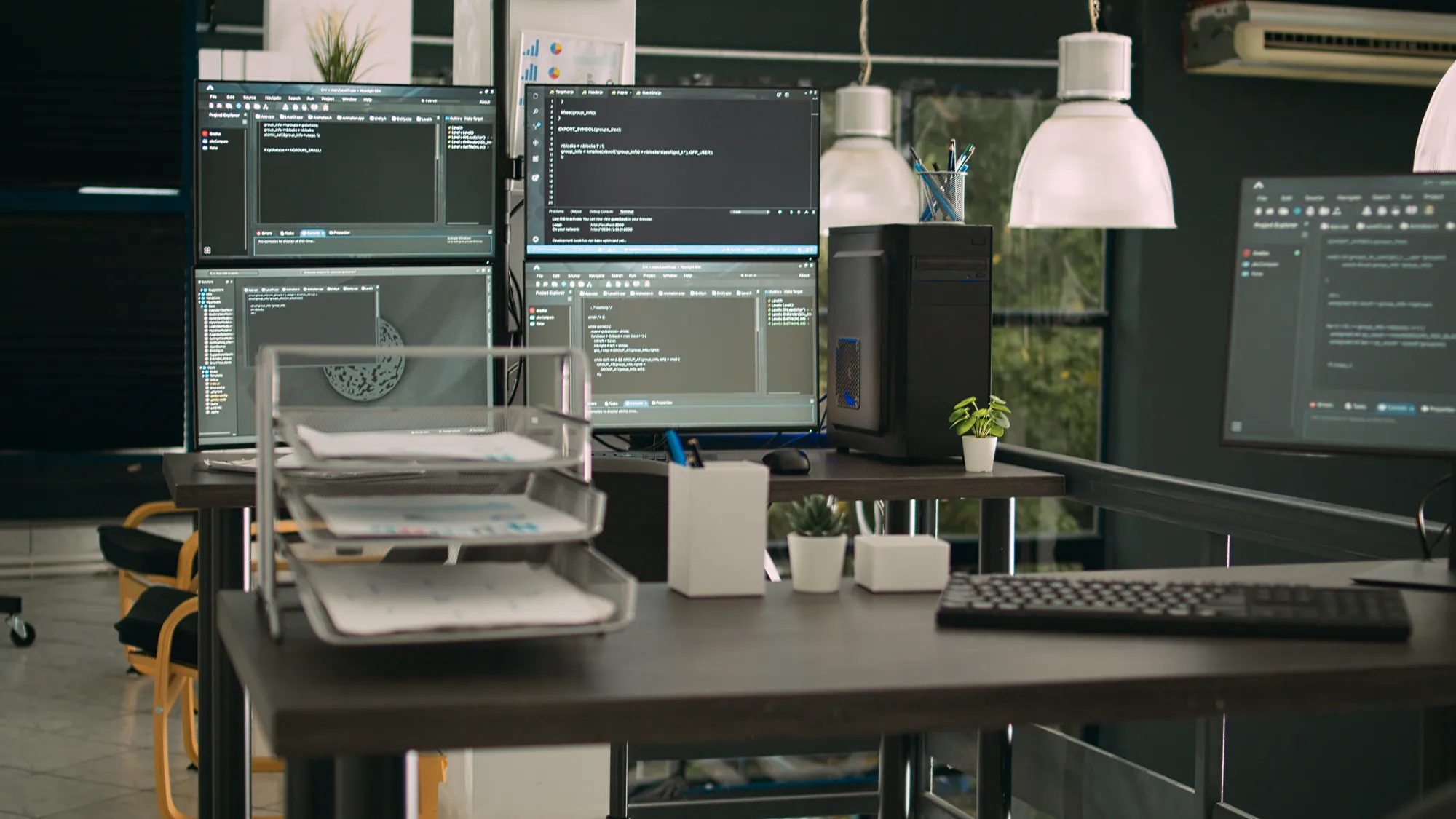 A computer desk with a keyboard and a monitor.