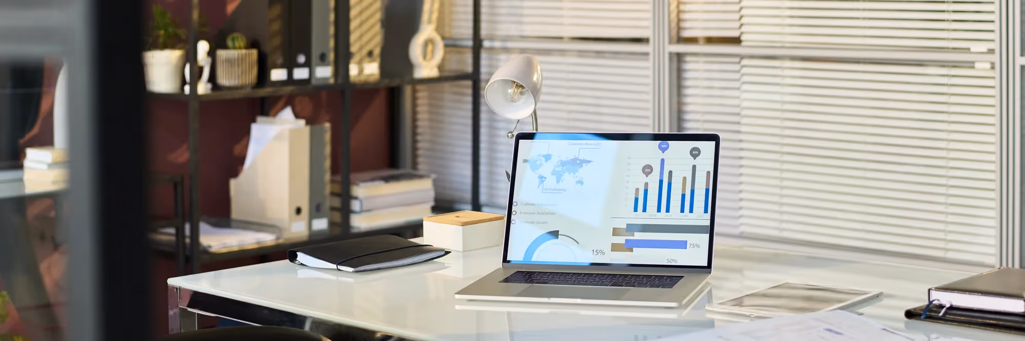 A laptop with a screen displaying graphs and charts.