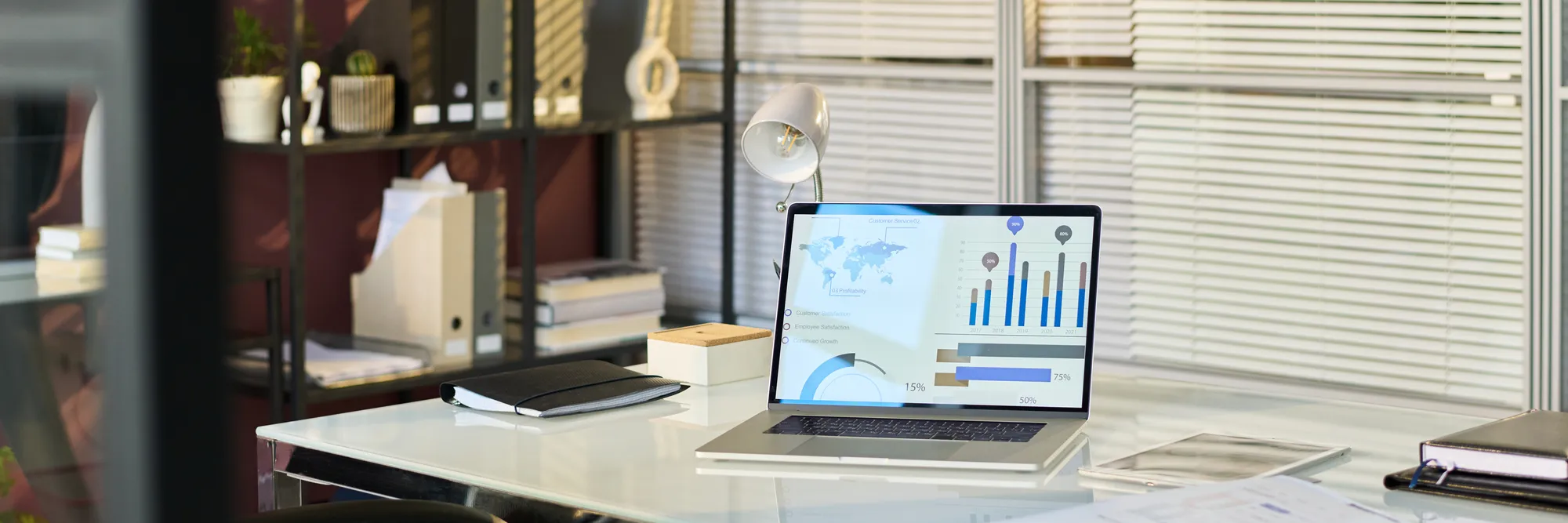 A laptop with a screen displaying graphs and charts.