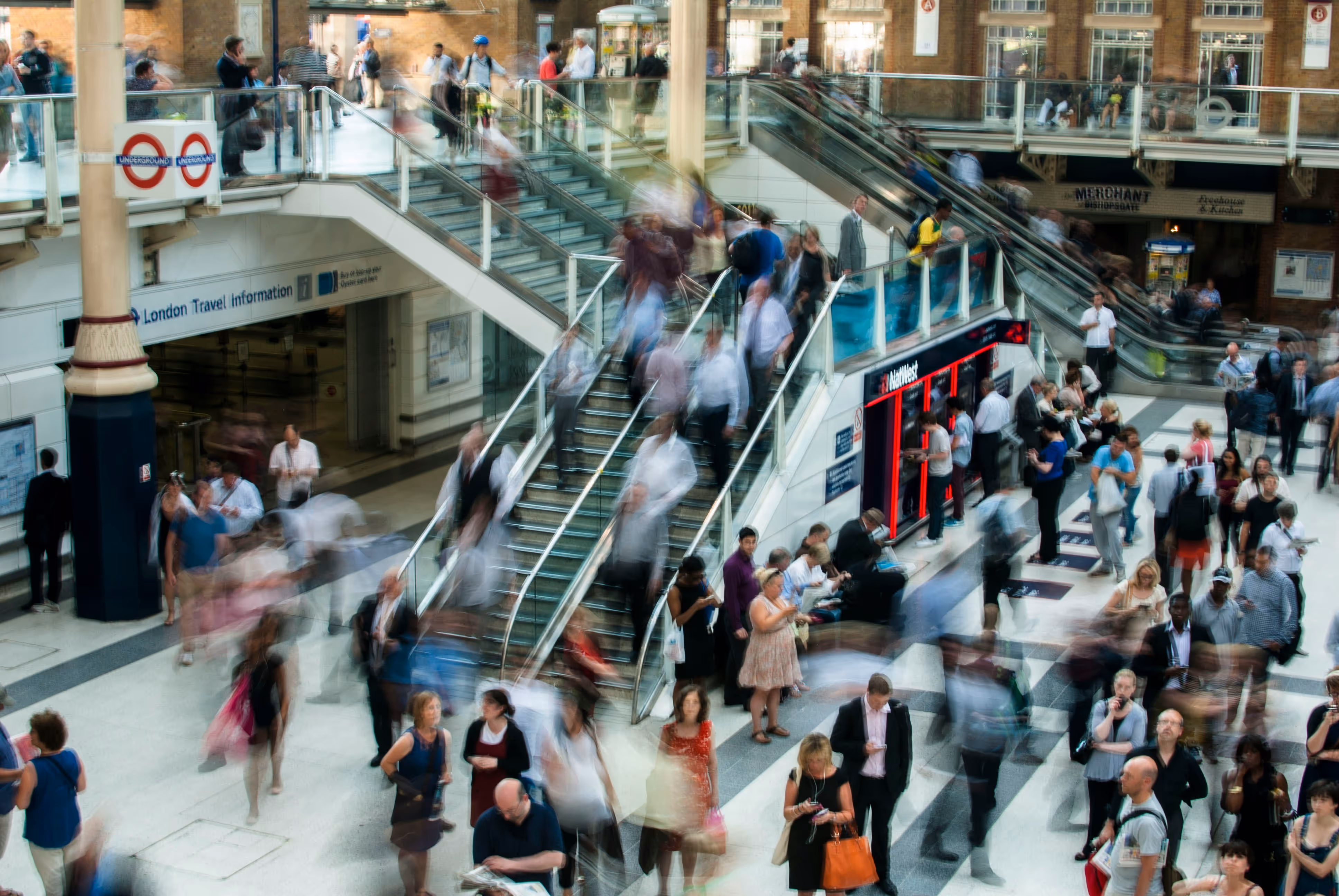 A blurry photo of a busy subway station.