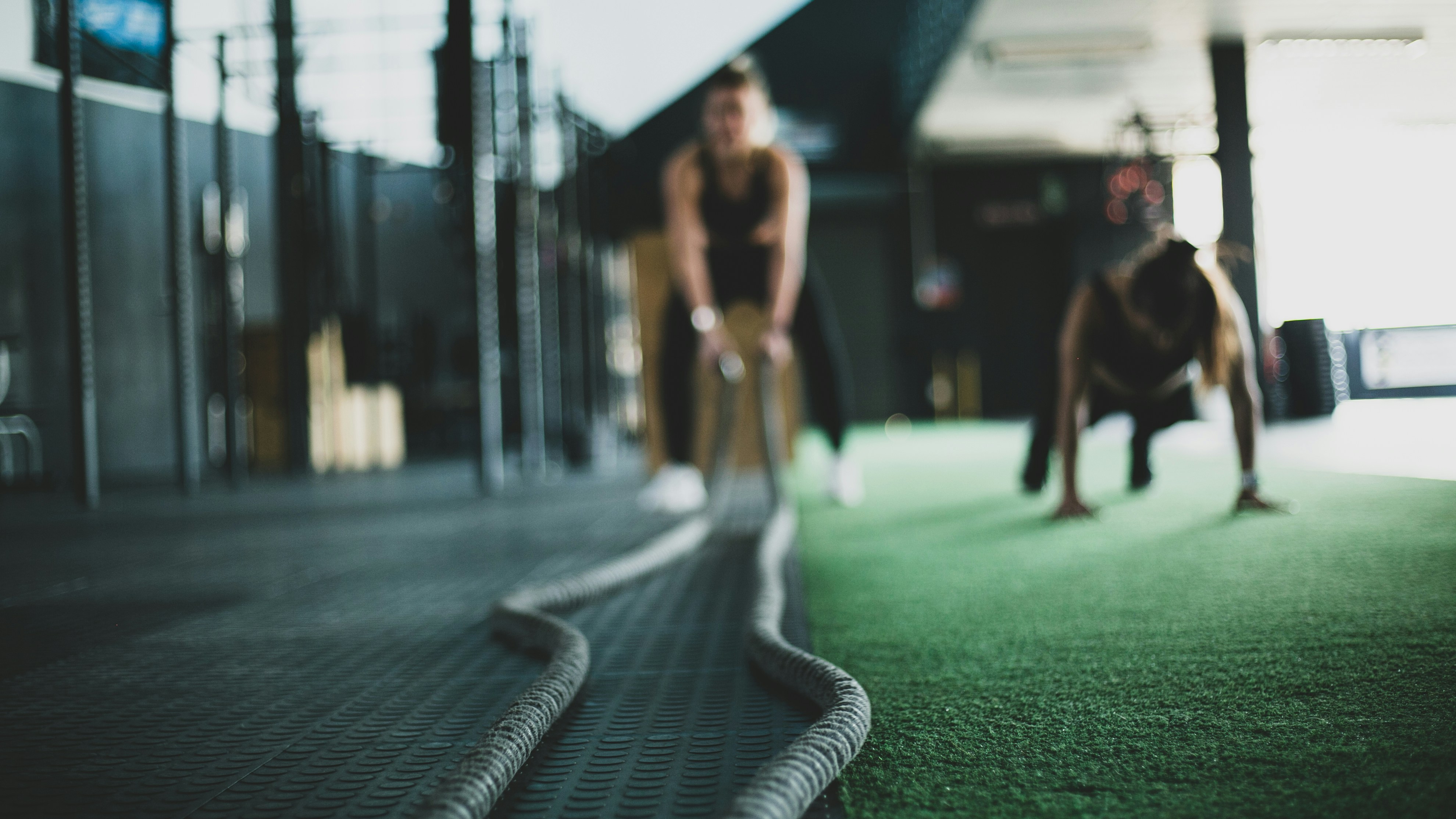 A woman is doing a workout on a rope.