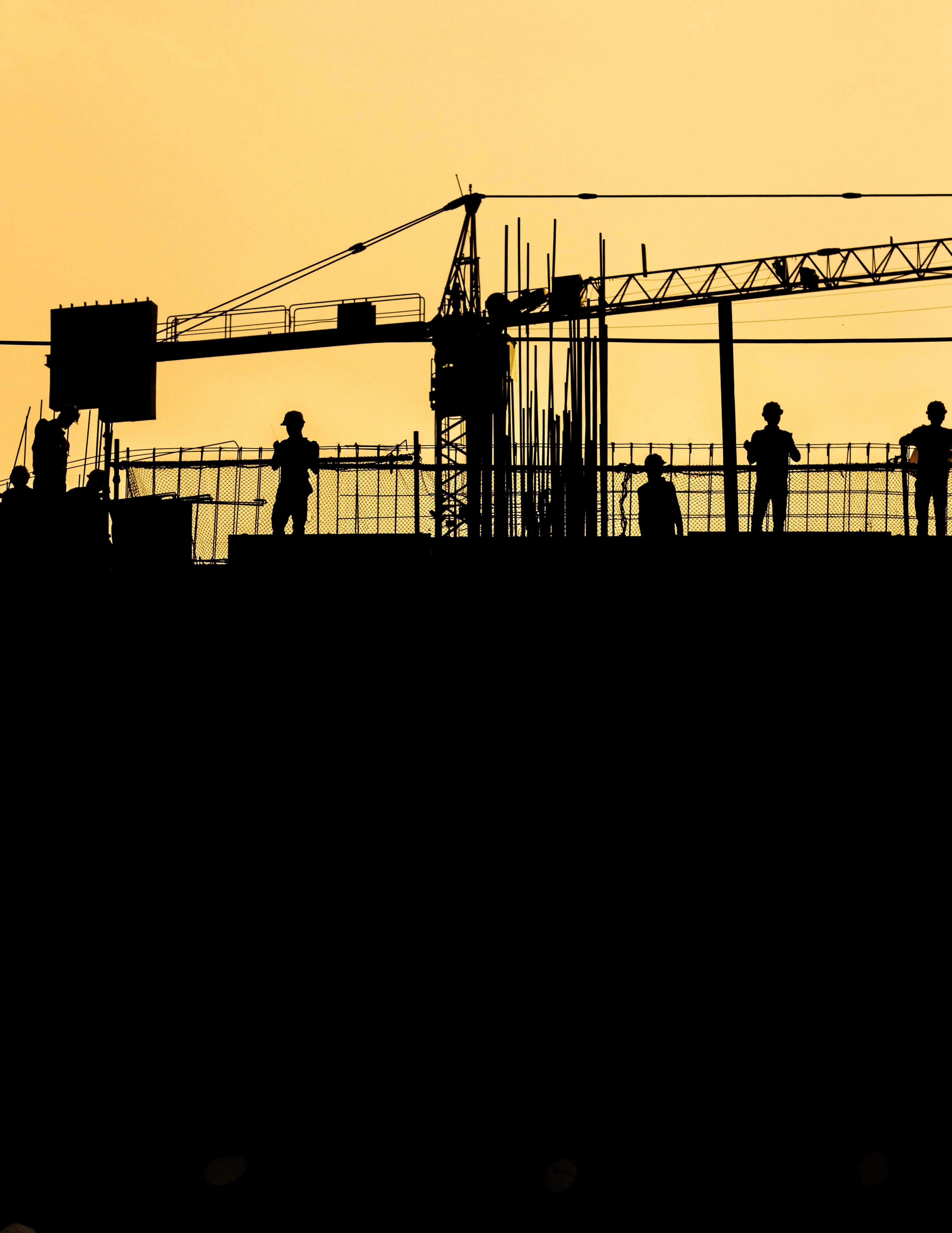A group of construction workers on a scaffolding.