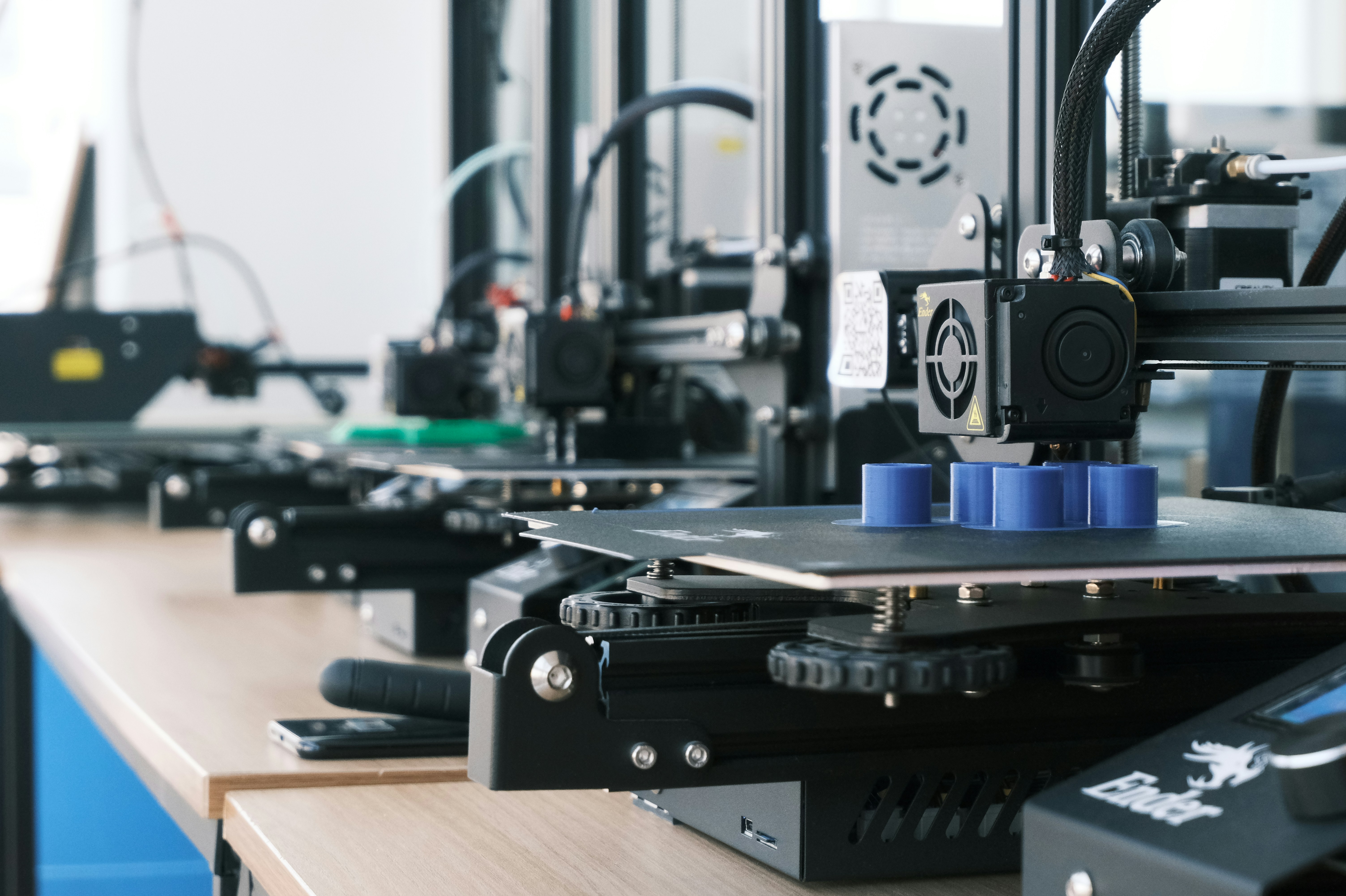 A 3D printer with a blue object on it.