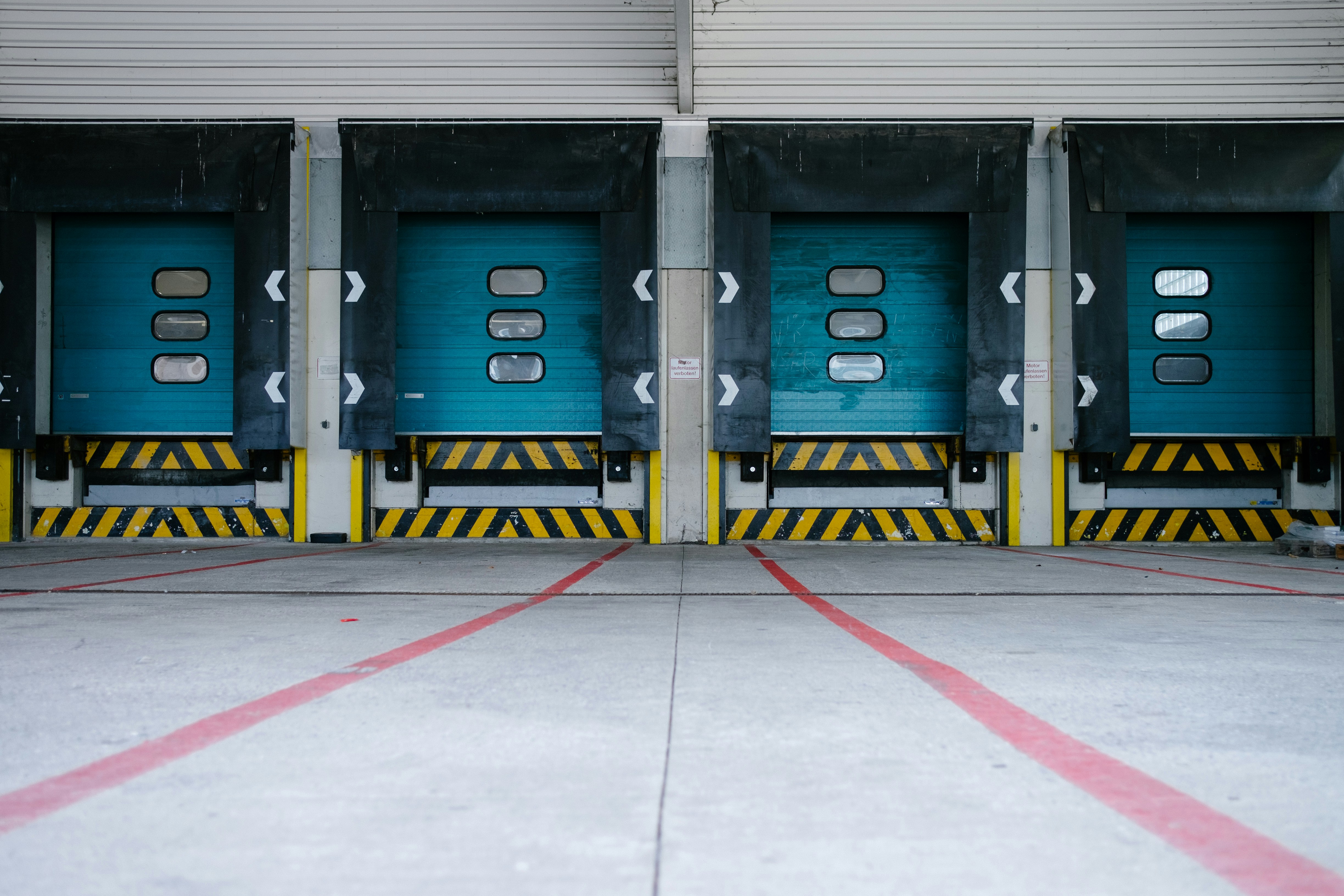 A large blue garage door with a yellow stripe.